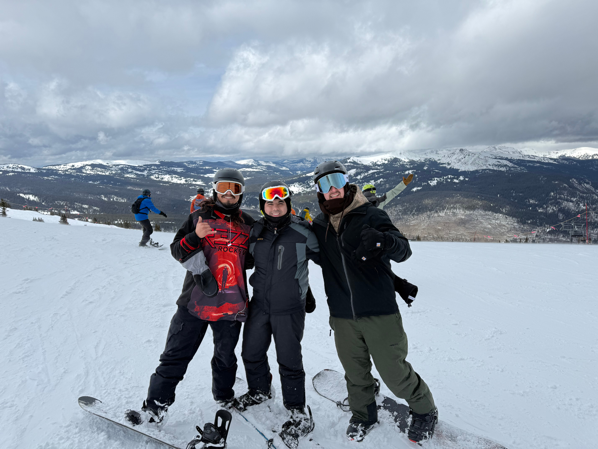 Hunter snowboarding with friends in the mountains